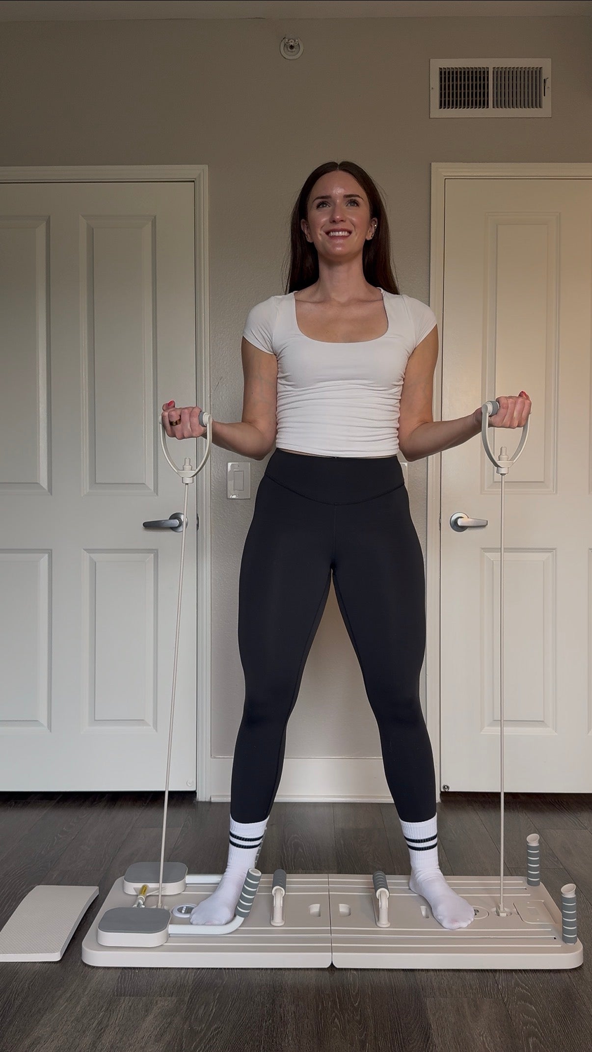 Flo customer exercising at home with her Pilates reformer