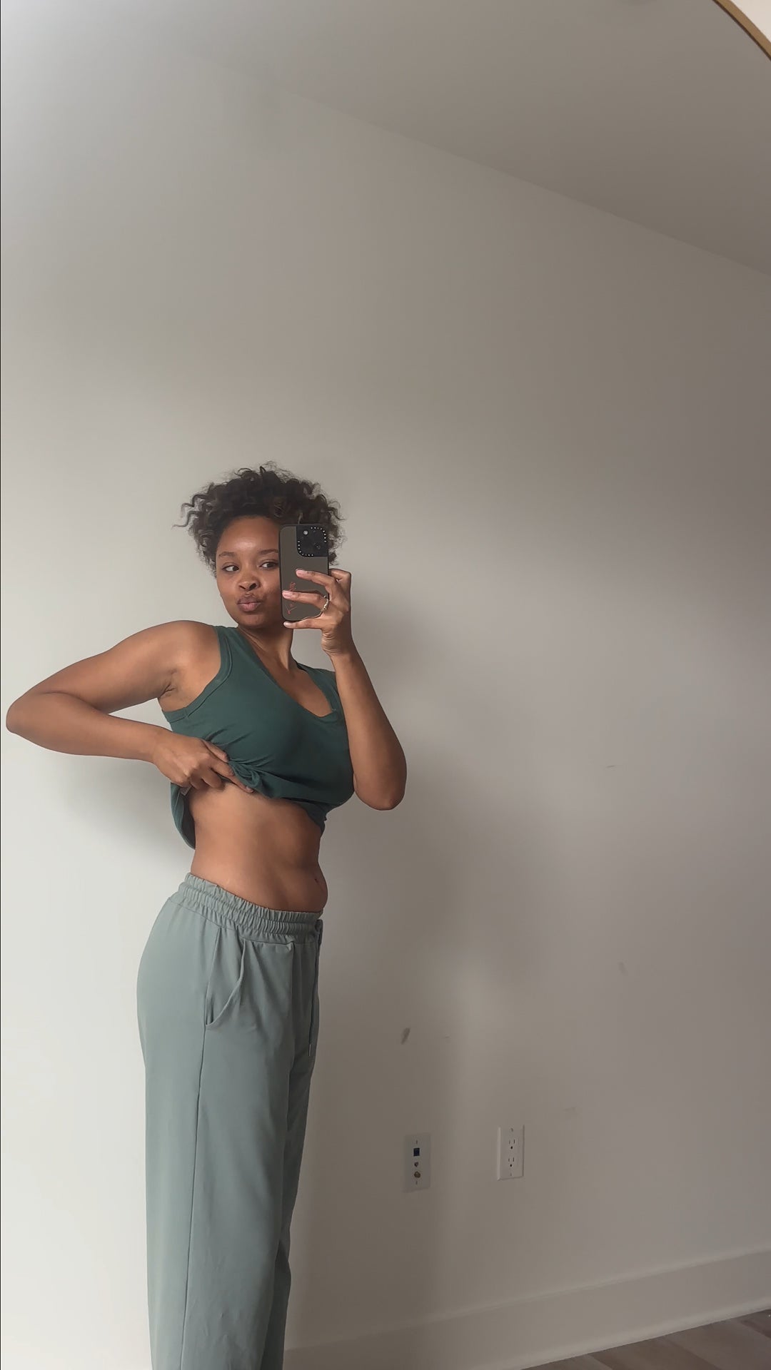 Flo customer showing her progress in a green workout top